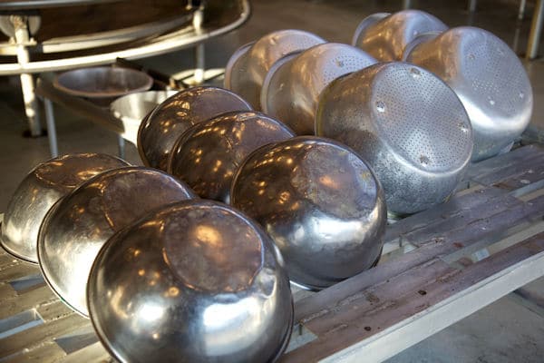 collection of stainless steel bowls and colanders 